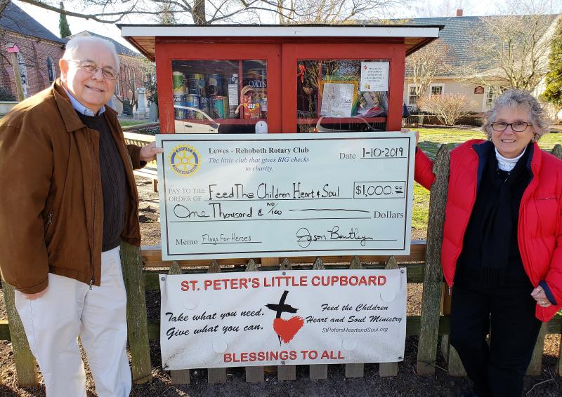 In front of the Little Cupboard at St. Peter’s Episcopal Church, Chuck Ward, left, Lewes-Rehoboth Rotarian and a St. Peter’s parishioner, presents a donation check for Feed the Children Heart and Soul to Chris Miller-Marcin, candidate for deacon at St. Peter’s. SUBMITTED PHOTO